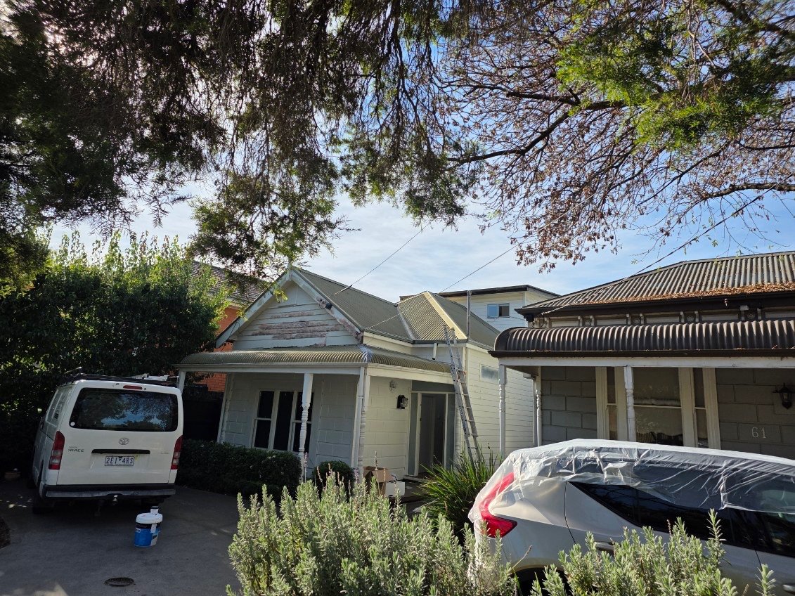 Before exterior house repaint photo showing an older weatherboard frontage before preparation and repainting